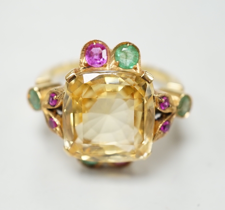 An 18ct and single stone yellow sapphire set dress ring, with emerald and ruby set setting and shoulders, size M, gross weight 9.4 grams.